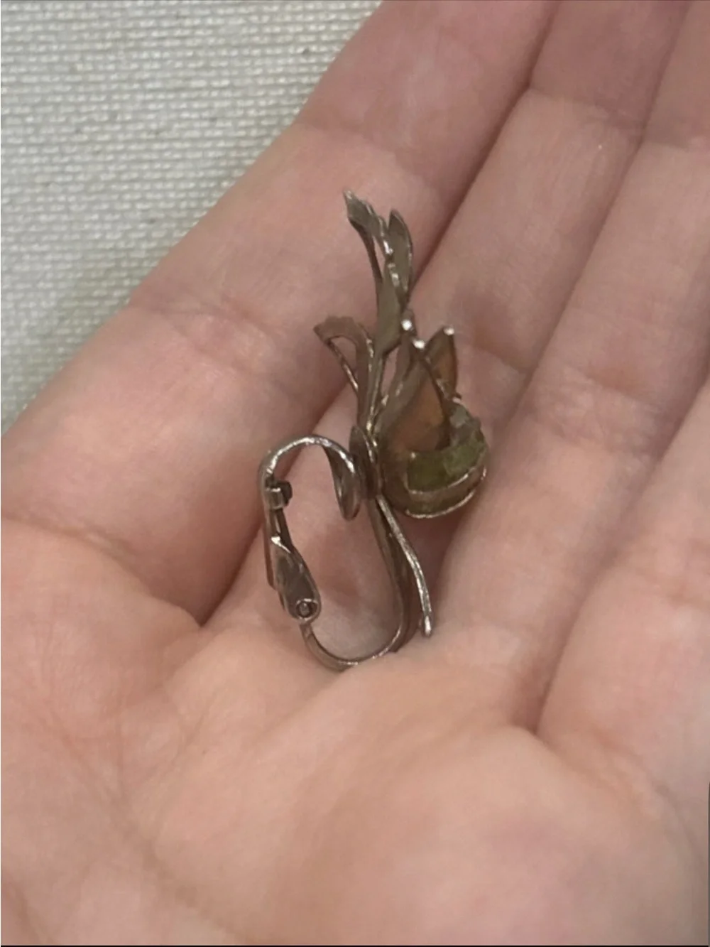 Gold tone leaf clip on earrings with natural peridot gemstone